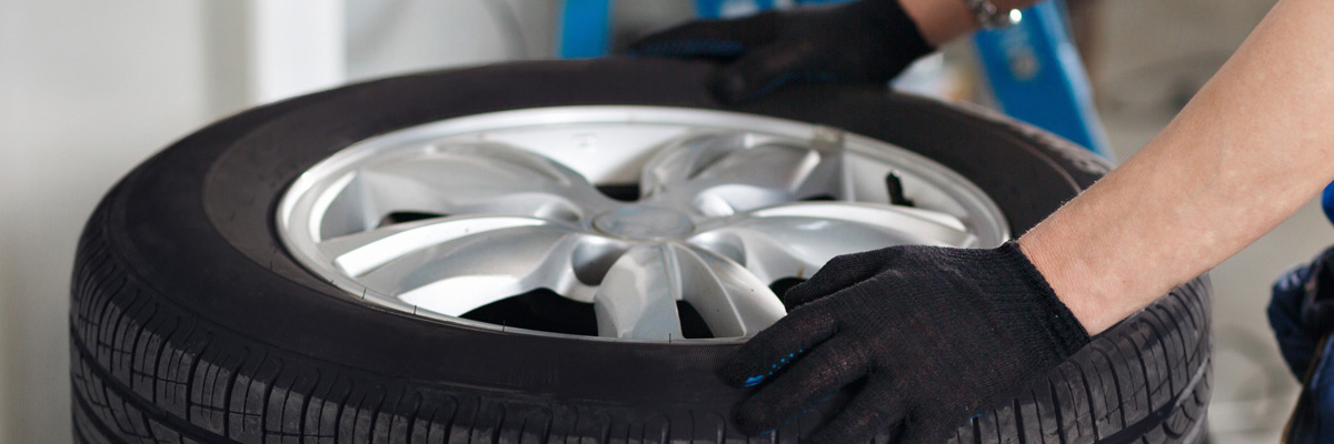 Mechanic holding onto a tyre - Tyres Preston